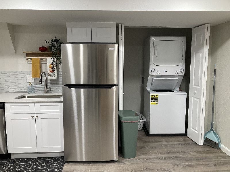 View of full kitchen and washer / dryer laundry closet. 