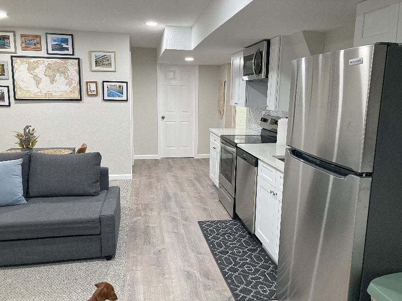Lengthwise view on living room with adjacent kitchen. 
