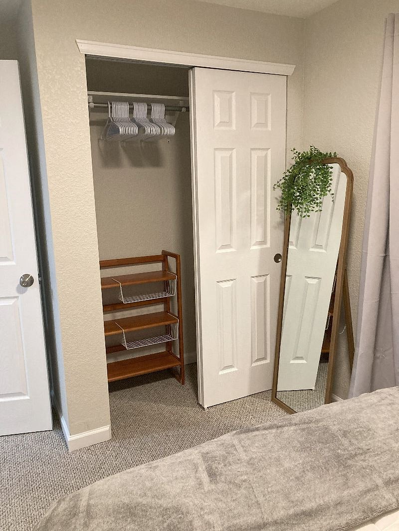 Bedroom closet area with full length mirror.