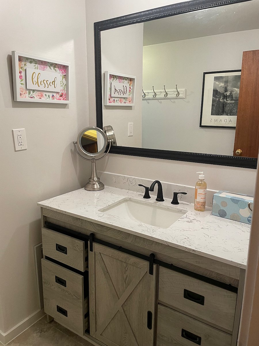 Clean, updated bathroom with full vanity and storage.
