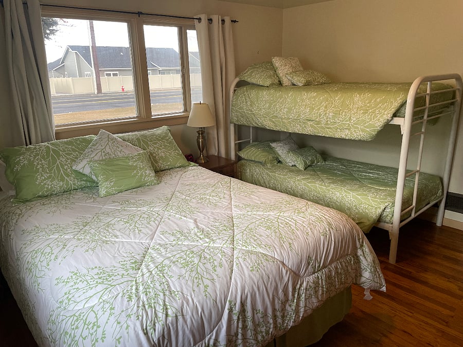 Second bedroom with queen bed and bunks flexible sleeping options.