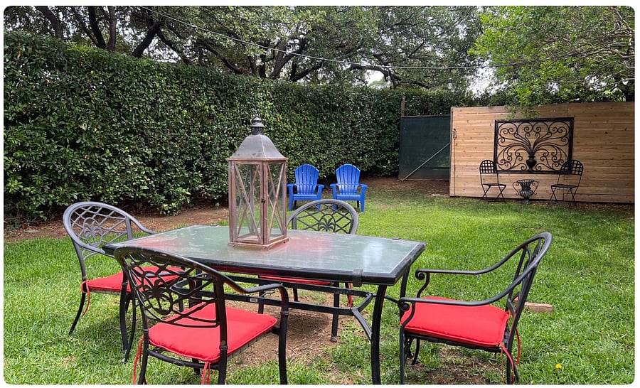Private back yard with a grill for a meal outdoors.