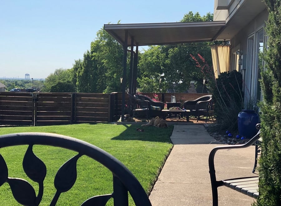 Back yard, with grill and dining table, view to the city