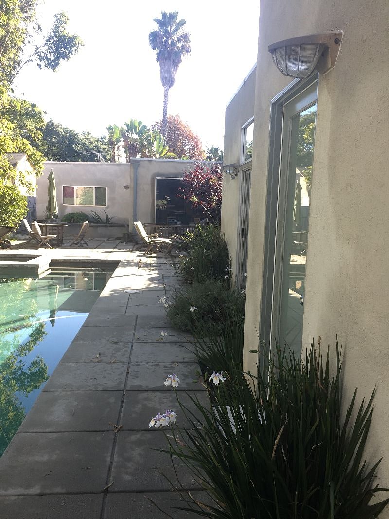 There is distance between the main house and the unit. Shared garden and poolside space.