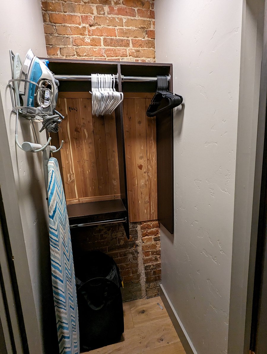 Bedroom closet, iron, and ironing board.