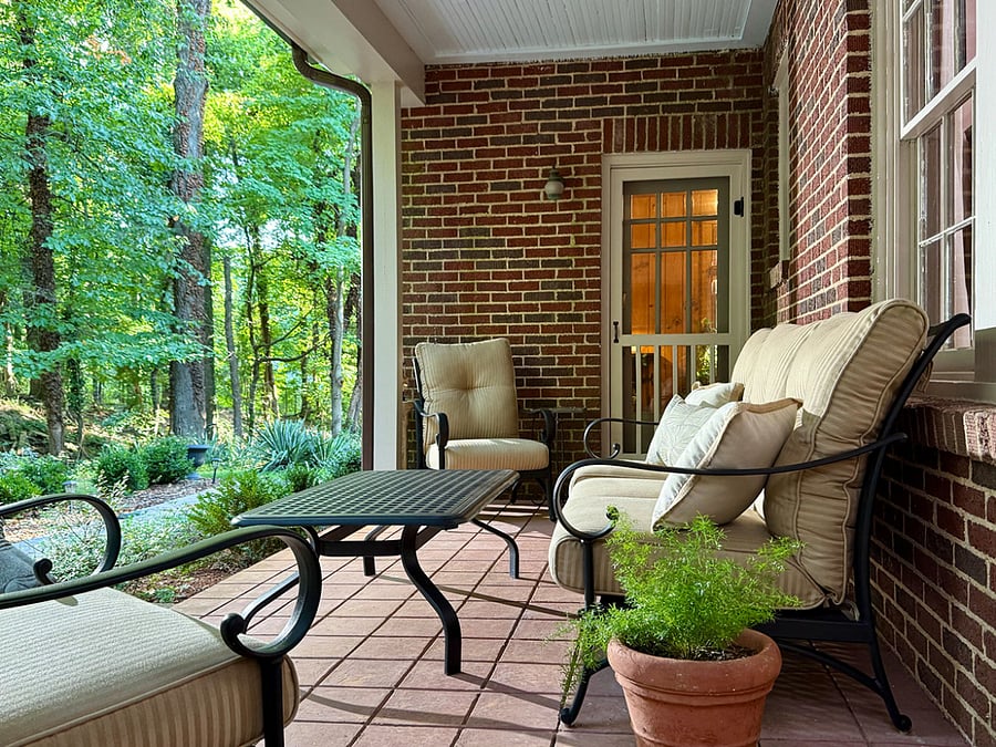 Covered porch between den and screened porch. Beautiful woods view