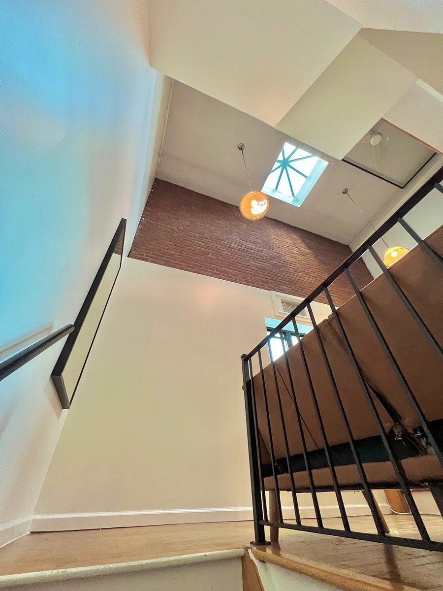 Stairway to 2nd floor featuring sky light
