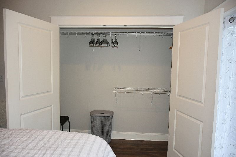 LARGE closet with hangers and hamper.