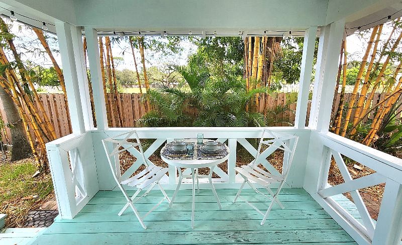 Beautiful Outodoor Bamboo Surounded Covered Porch Area designed for dining, with fairy lights at night, and fan for keeping cool!