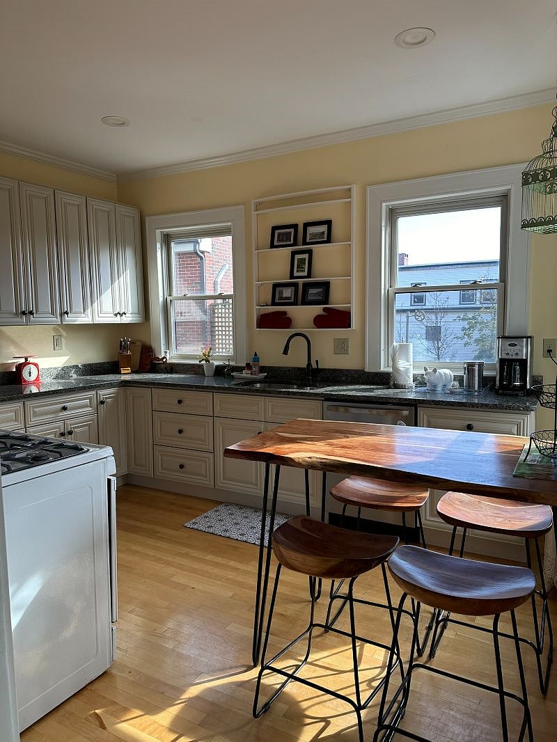 Spacious sun filled eat in kitchen with all of the conveniences: garbage disposal, full size dishwasher, lower and upper cabinets with granite countertops.