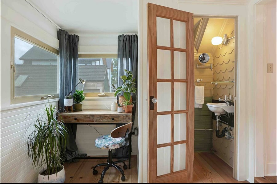 Private master suite has a cozy work area with south facing windows, next to private half bath
