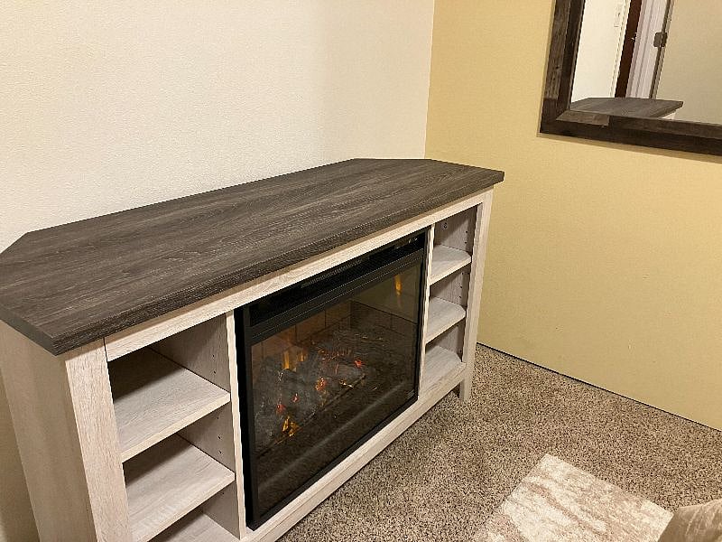 Basement room with electric fireplace console