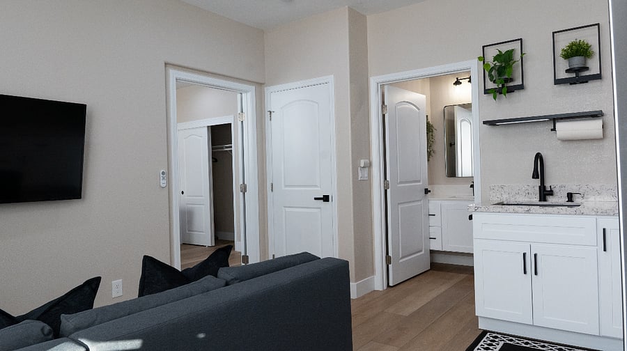 Living area includes foldable dining table, pull-out sofa bed, 50" Smart TV