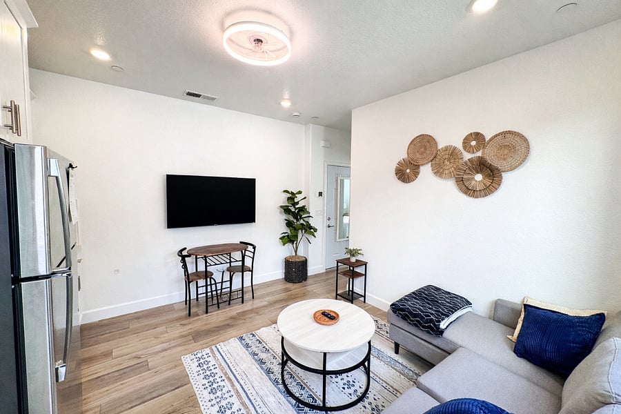 Relax in the cozy living area with a plush sofa and a 55-inch smart TV  perfect for unwinding after a long day 