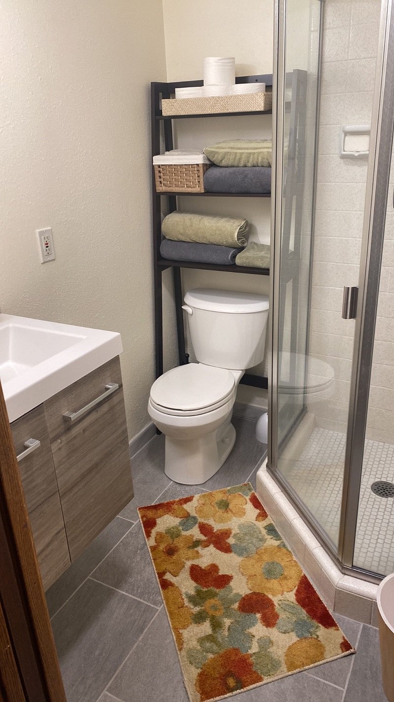 the cottage bathroom is small but cute. we just remodeled it with new vanity, flooring, and shower surround.