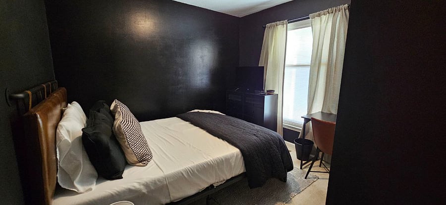 First bedroom with Queen-sized mattress, spacious closet, a desk, a dresser, room-darkening/blackout curtains, and a Roku flatscreen TV.