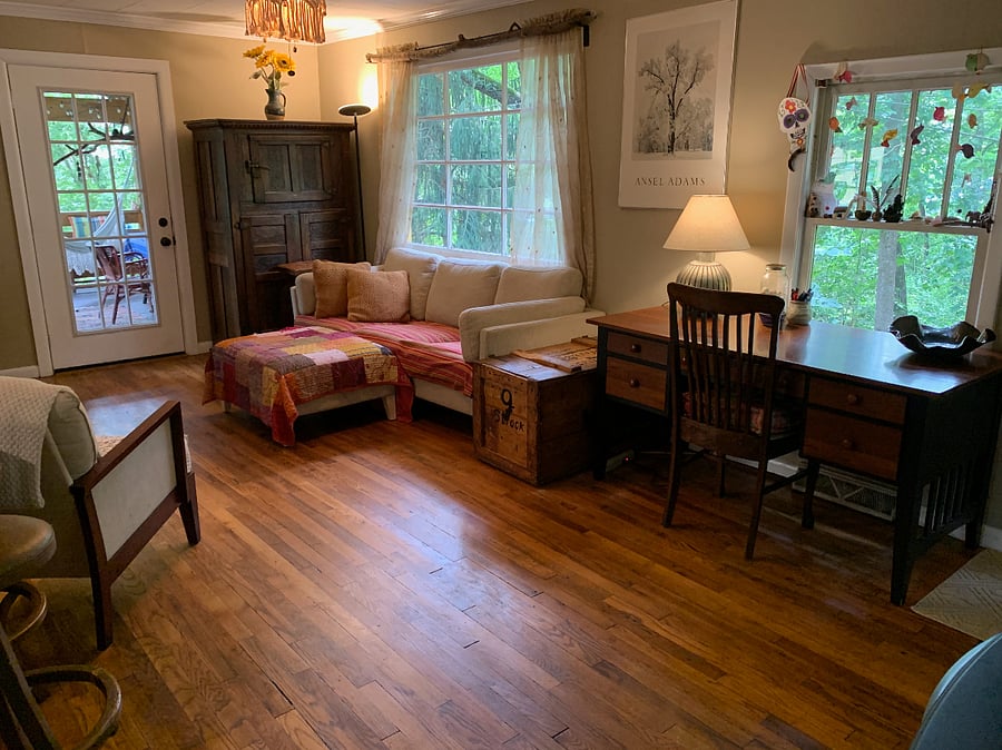 Living room with desk overlooking the woods.