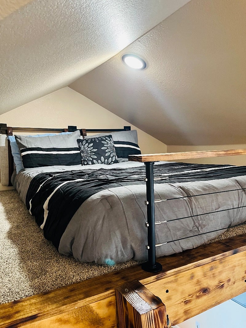 This optional sleeping area is a sleeping loft with about 4 feet of clearance from the bed. It's better suited for is small person or child.