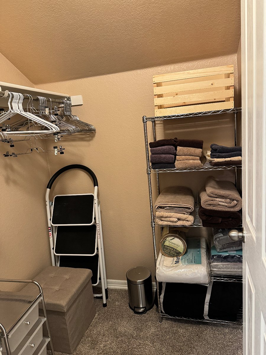 Walking in closet.  Storage shelve with sheets and towels.