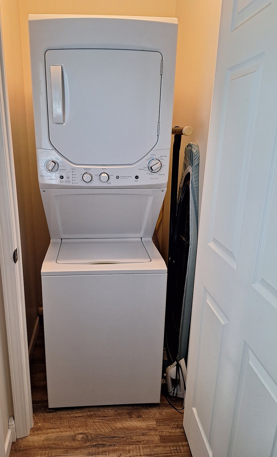 Stackable washer & dryer in bedroom closet.