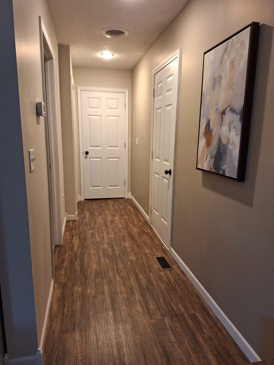 Small hallway leading to bathroom and bedroom.