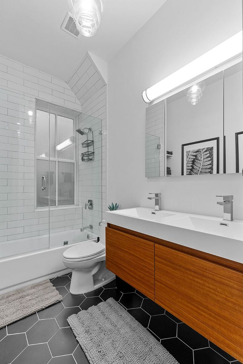 Updated bathroom with double vanity and glass shower door
