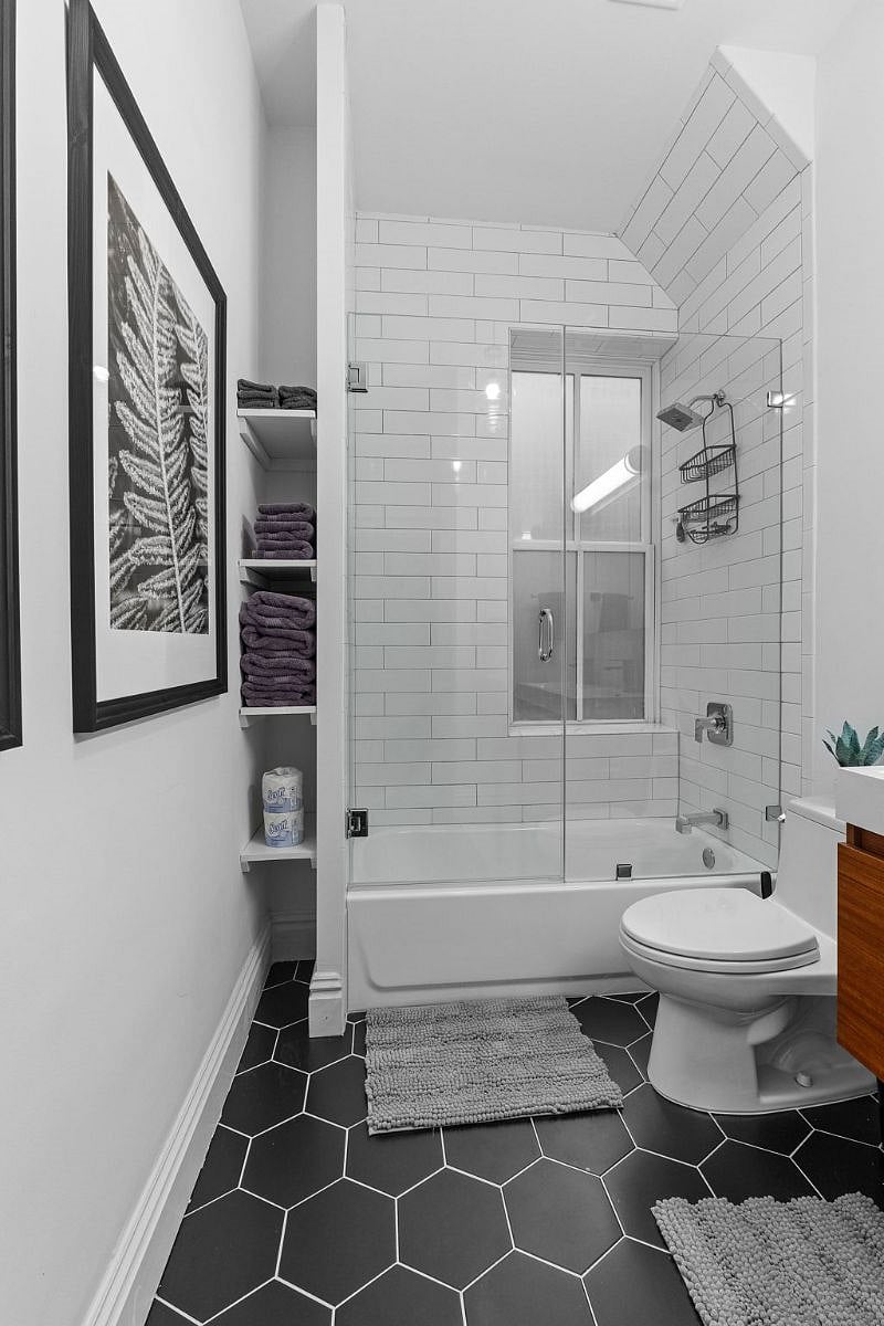 Updated bathroom with double vanity and glass shower door