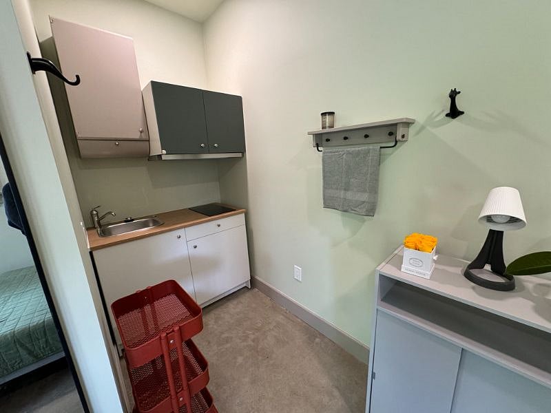 Kitchenette with electric stove and sink
