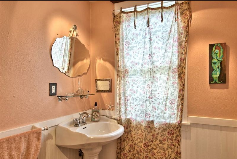 Second floor shared bathroom, with plenty of shelf space and amenities.