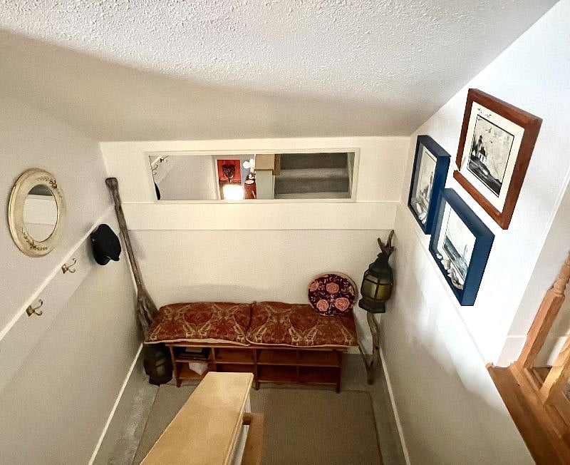 Third floor landing, shoe removing bench with plenty of storage, brand new carpet and it feels amazing!