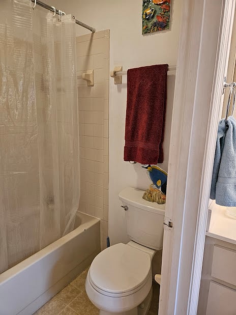 Master tub/shower and toilet separate from vanity area.