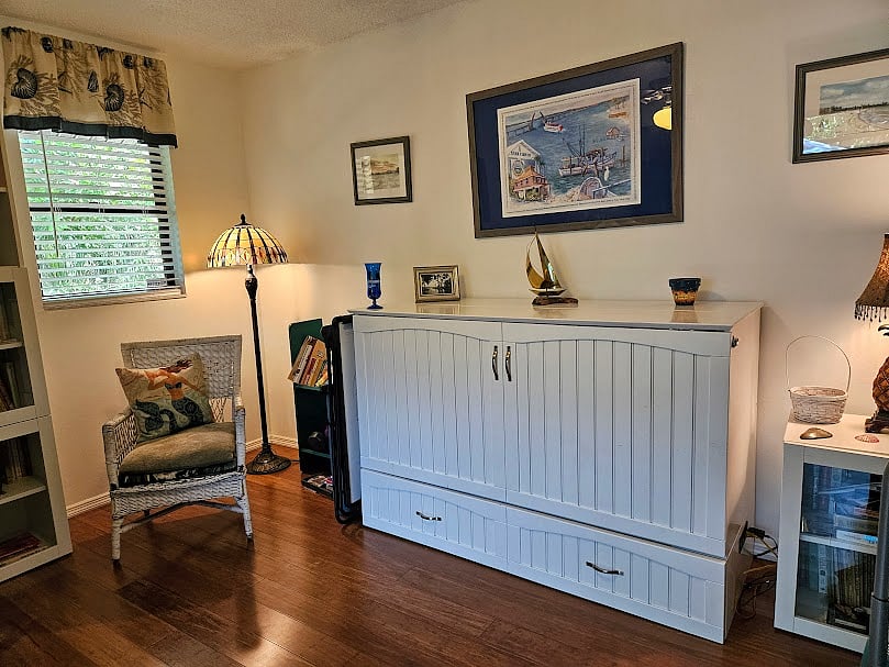 Guest room. Chest opens to murphy queen size bed with 5'' memory foam mattress. Room can be used as office or workout room!
