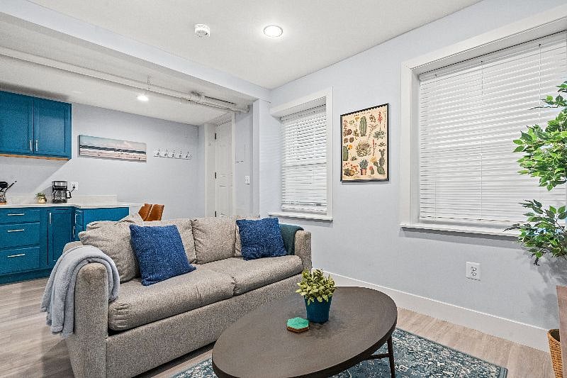 Living room windows have blinds for privacy