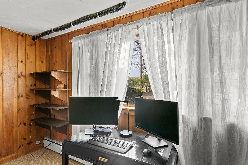 Downstairs office with dual monitors and docking station.