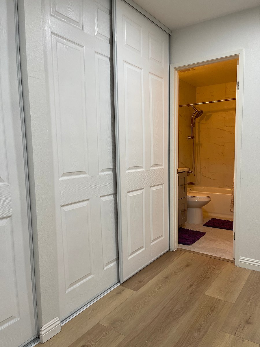 First bedroom with a large closet and attached bathroom.