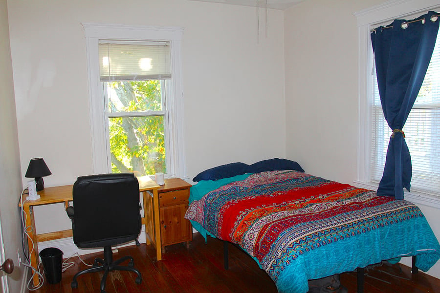 Rear bedroom includes full bed, chest of drawers, desk & inbuilt closet. Heated & cooled with heat-pump mini split