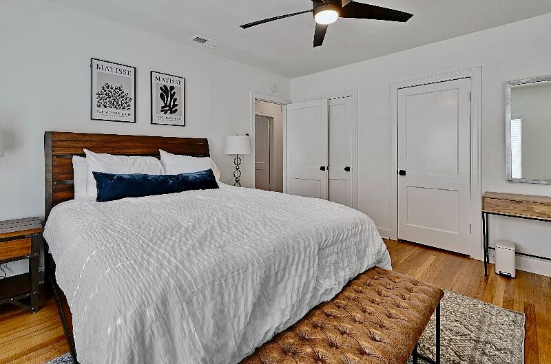Main bedroom with two closets and a console table, queen bed