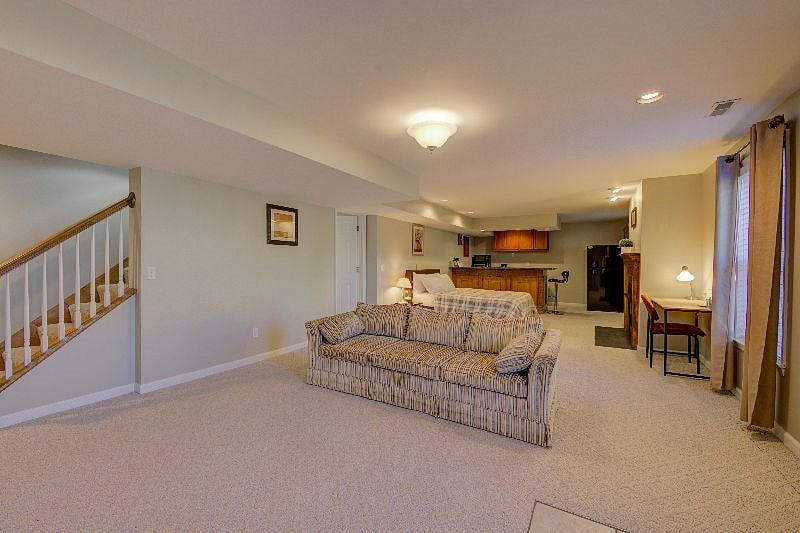 Inside view showing 3 seater couch and reading desk.