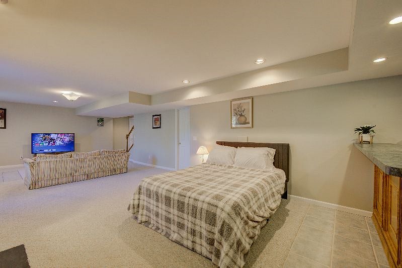 Side view of home showing queen bed, couch and TV