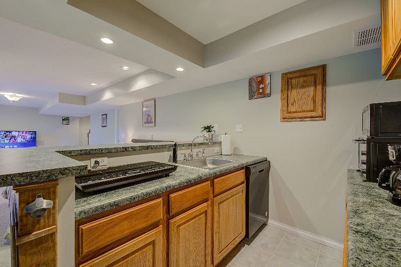 Kitchen with view of cooktop and dishwasher.