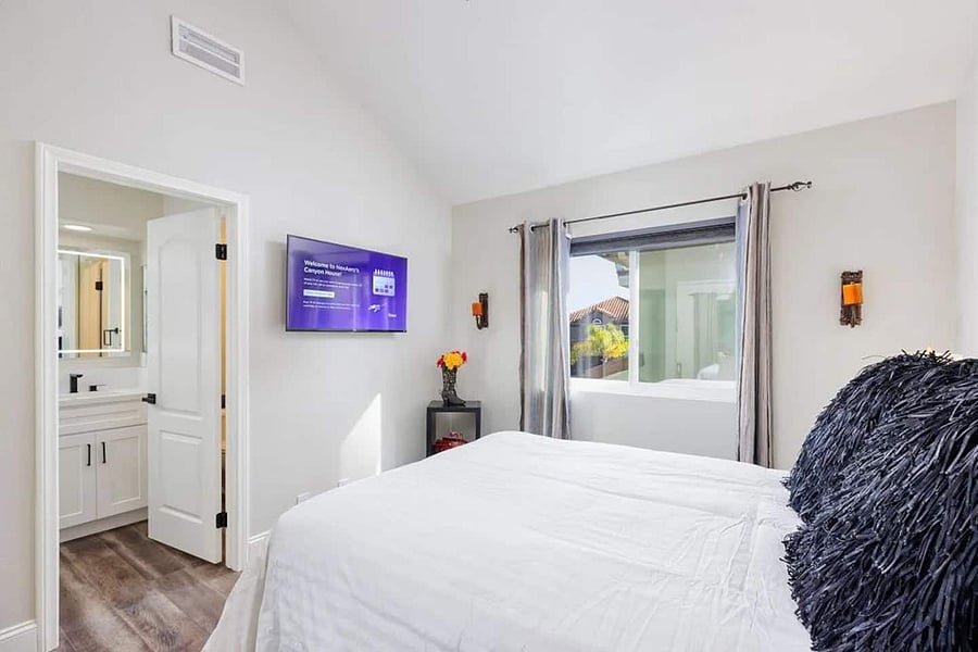 A cozy bedroom with a warm, inviting atmosphere. Equipped with smart tv and Alexa