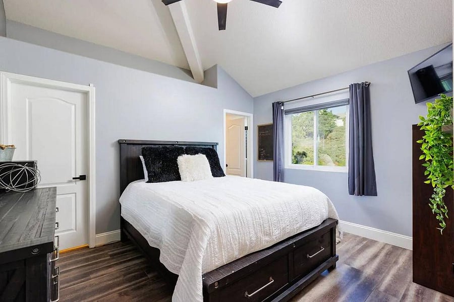 A cozy bedroom with a warm, inviting atmosphere. Equipped with smart tv and Alexa.  Newly remodeled private  full bath with luxury rain fall showers walk in closet and plenty of storage.