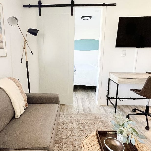Barn door leads to the bedroom.