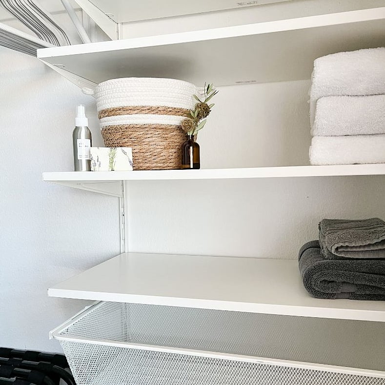 Full size closet with storage and two luggage racks.