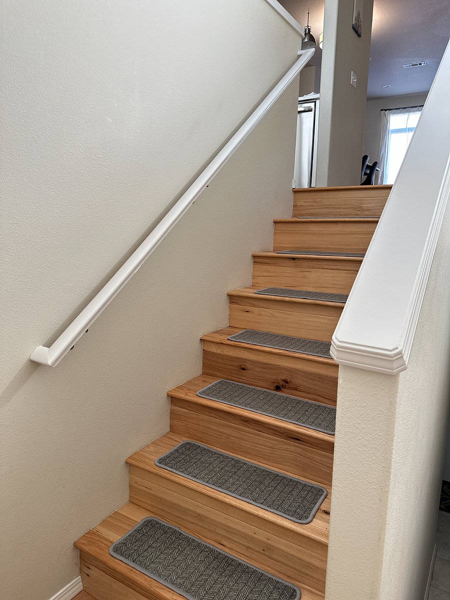 Interior stairs leading from entry landing to living/kitchen level