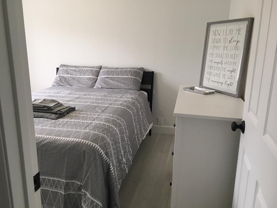 bedroom#2w/ a queen-size bed, a closet (w/ lots of hangers &a laundry basket), and a good size dresser.