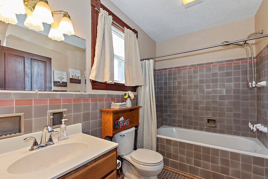 Tiled bathroom. Bathtub has been newly reglazed. Handheld shower head. Laundry facilities available in the basement.
