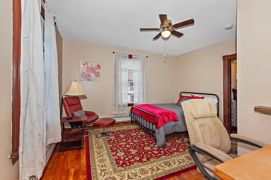 Guest bedroom #1 is $1150 monthly and features a spacious walk-in closet/dressing room, desk, lounger chair, queen size bed, ceiling fan, code lock on door, and a window view of the iconic Frog Bridge.