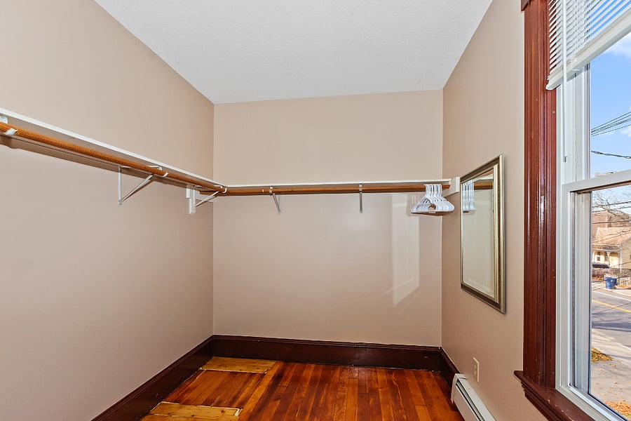 Walk-in closet for Guest Room #1. Very spacious with mirror and window.