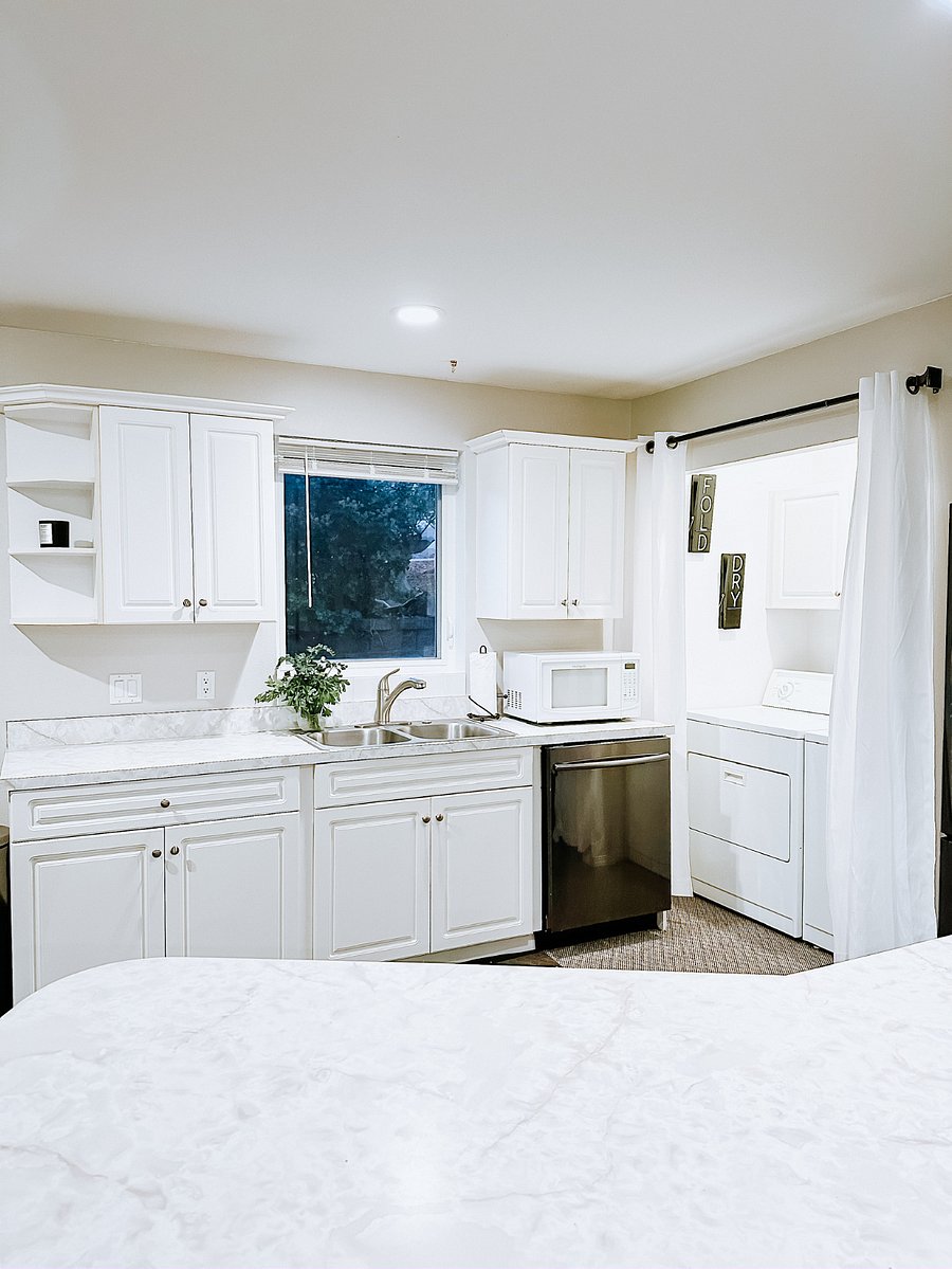 Kitchen area with washer and dryer space